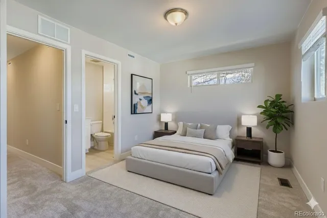 a bedroom with a bed and a potted plant
