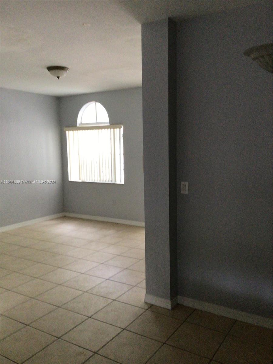 4941 Southwest 135th Way Miramar, FL 33027 - Photo 4 of 11 an empty room with windows
