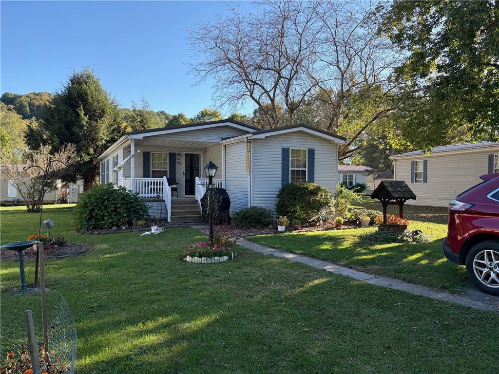 910 Robin Drive Apollo, PA 15613 - Photo 2 of 22 a front view of a house with garden and trees