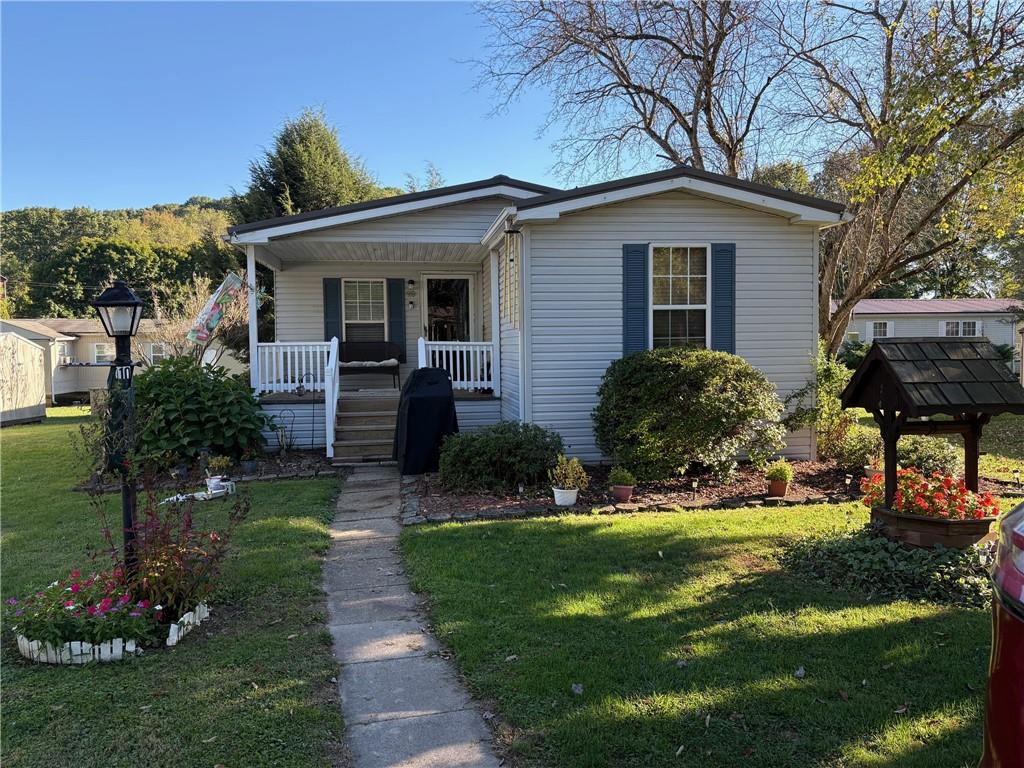 910 Robin Drive Apollo, PA 15613 - Photo 3 of 22 a front view of a house with a yard table and chairs