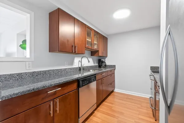 a kitchen with stainless steel appliances granite countertop a sink stove and refrigerator