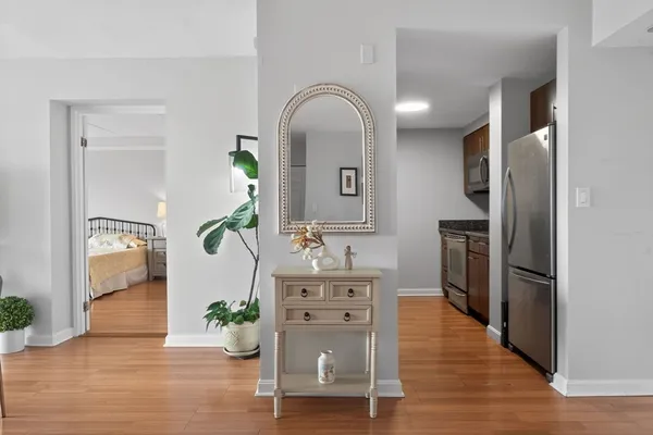 a living room with furniture and a wooden floor