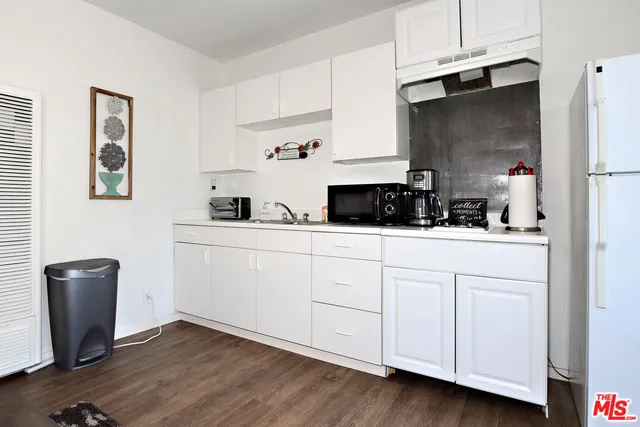 a kitchen with a sink and a refrigerator