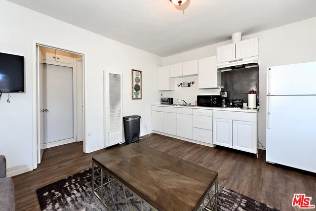 a kitchen with a sink cabinets and wooden floor
