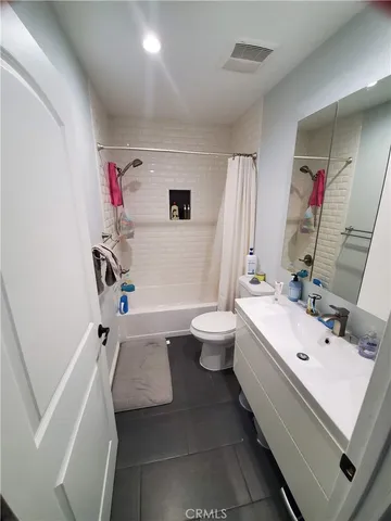 a view of walk in closet with clothes