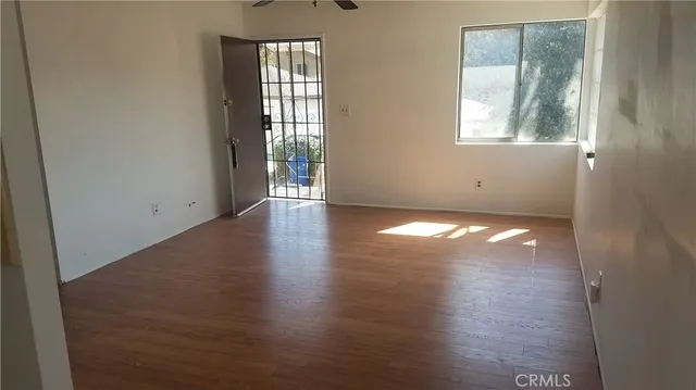 a view of a room with wooden floor