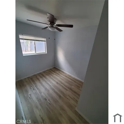 a view of an empty room and wooden floor