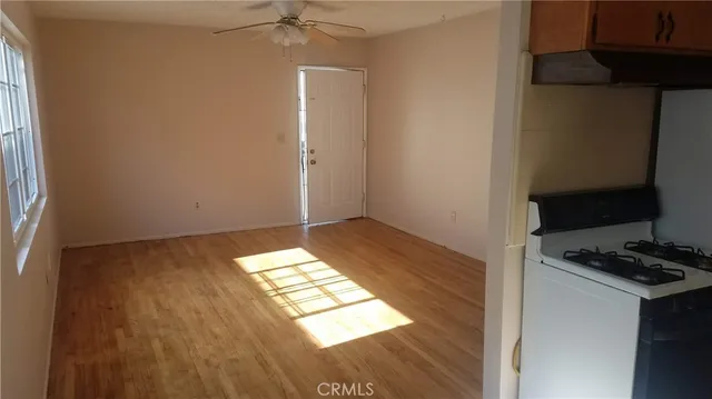 a view of an empty room with wooden floor