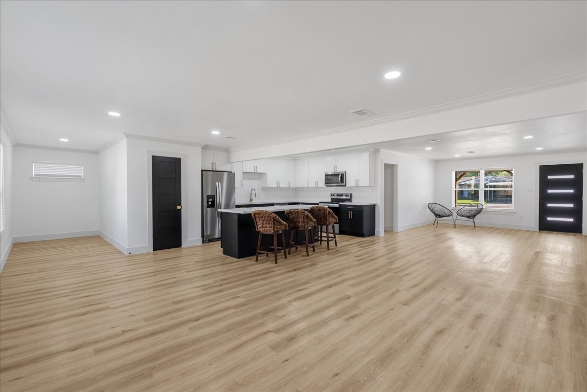 5219 Cosby Street Houston, TX 77021 - Photo 10 of 50 The ultimate Great Room. This expansive layout dissolves the barriers between lounging and dining, creating a cohesive environment for high-profile entertaining.