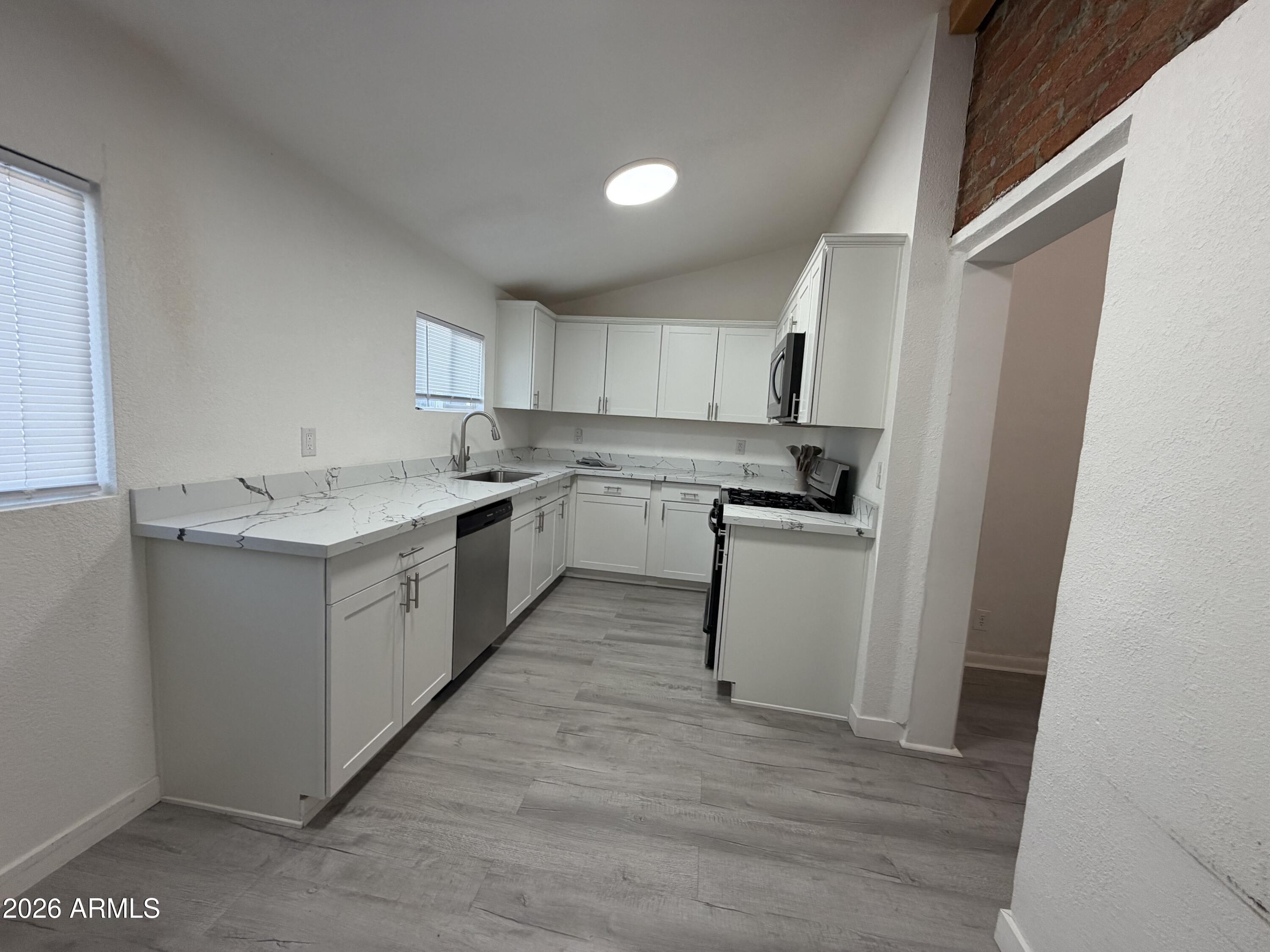 360 Pinal Street Globe, AZ 85501 - Photo 4 of 13 a kitchen with a sink cabinets and wooden floor