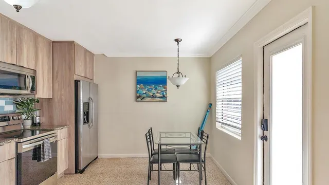 a kitchen with stainless steel appliances a refrigerator and a stove