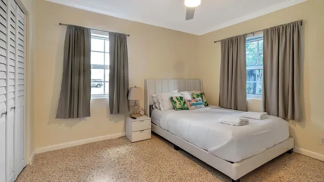 a bedroom with a bed and a window