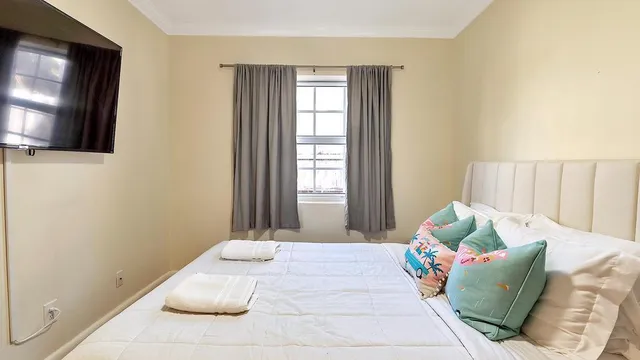 a bedroom with a bed and a flat screen tv