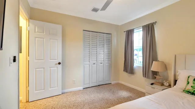 a bedroom with a bed and a mirror