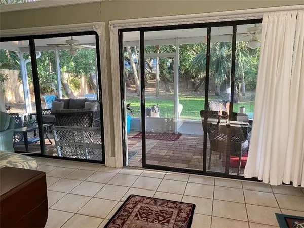 a view of a living room and balcony with furniture
