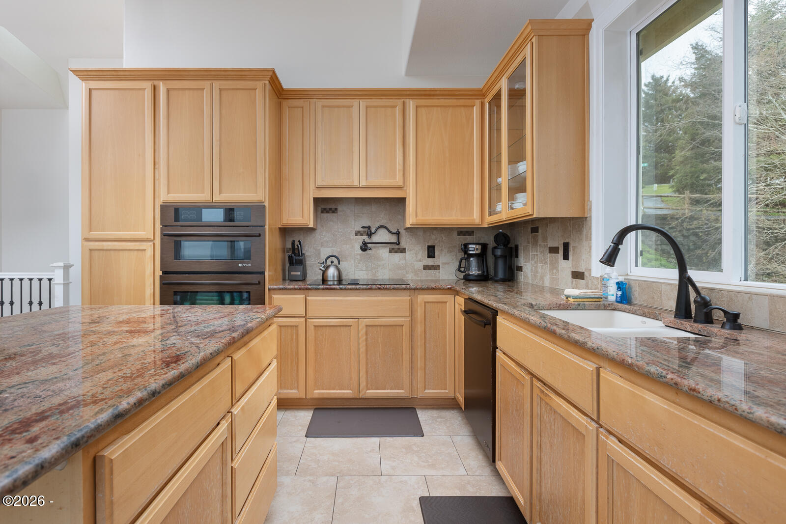 7415 East Summit Road Pacific City, OR 97135 - Photo 11 of 44 a kitchen with stainless steel appliances granite countertop a sink a stove and cabinets