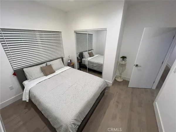 a bedroom with a bed and a large mirror