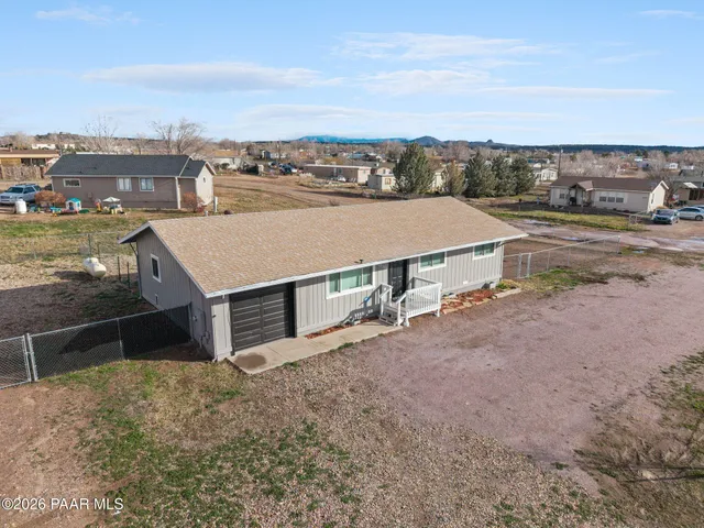 an aerial view of a house with a yard and lake view