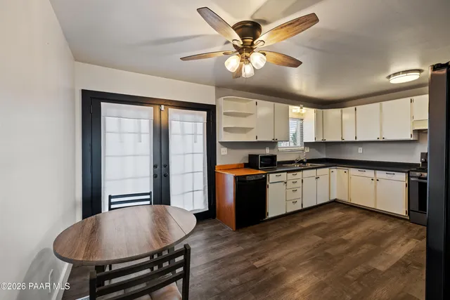 a large kitchen with a large window cabinets and stainless steel appliances