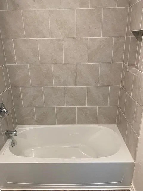521 Locksley Cove Jarrell, TX 76537 - Photo 7 of 9 a bathroom with a bathtub and a window