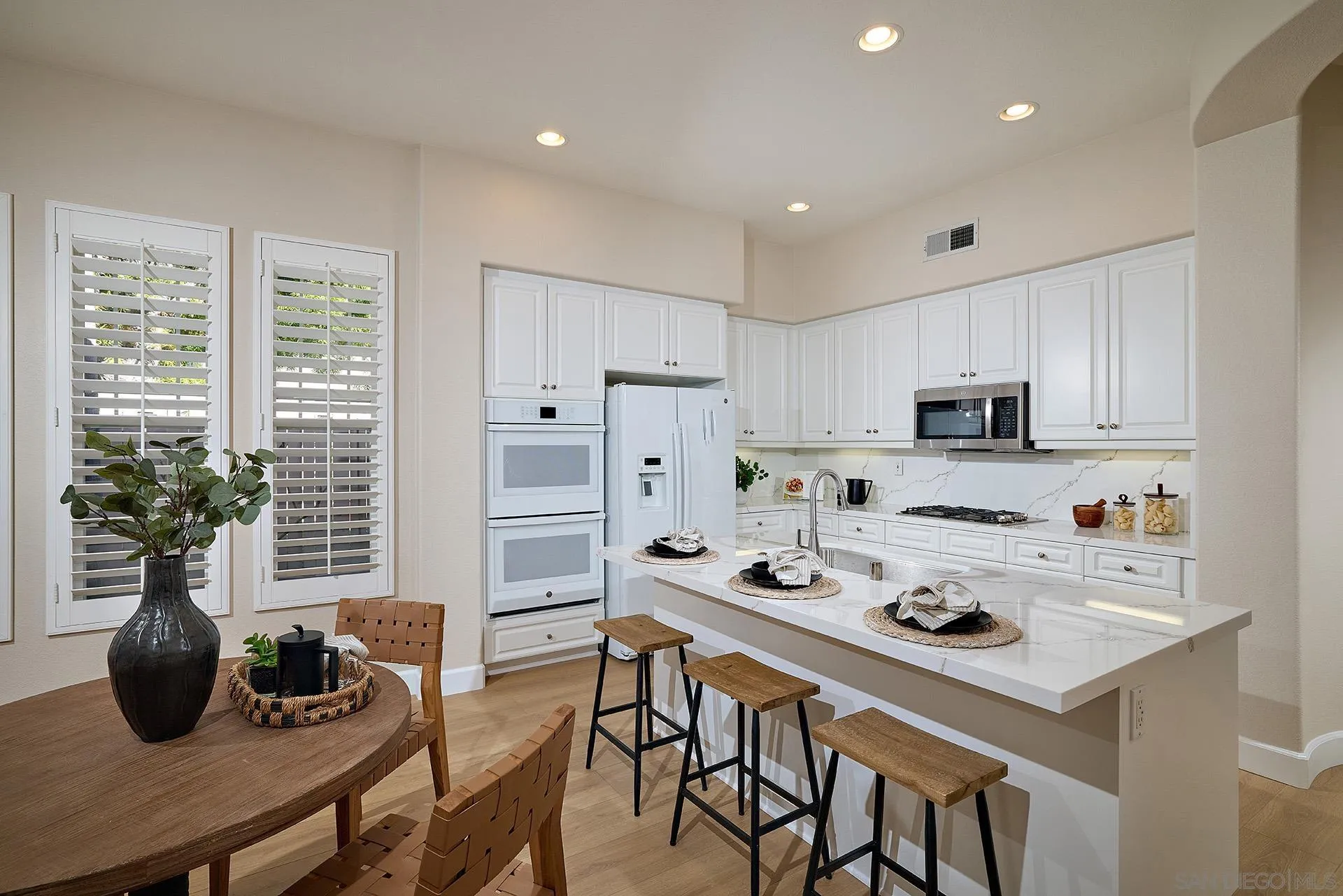 6109 Paseo Tesoro Carlsbad, CA 92009 - Photo 12 of 34 a kitchen with stainless steel appliances kitchen island granite countertop a stove a sink a refrigerator and cabinets