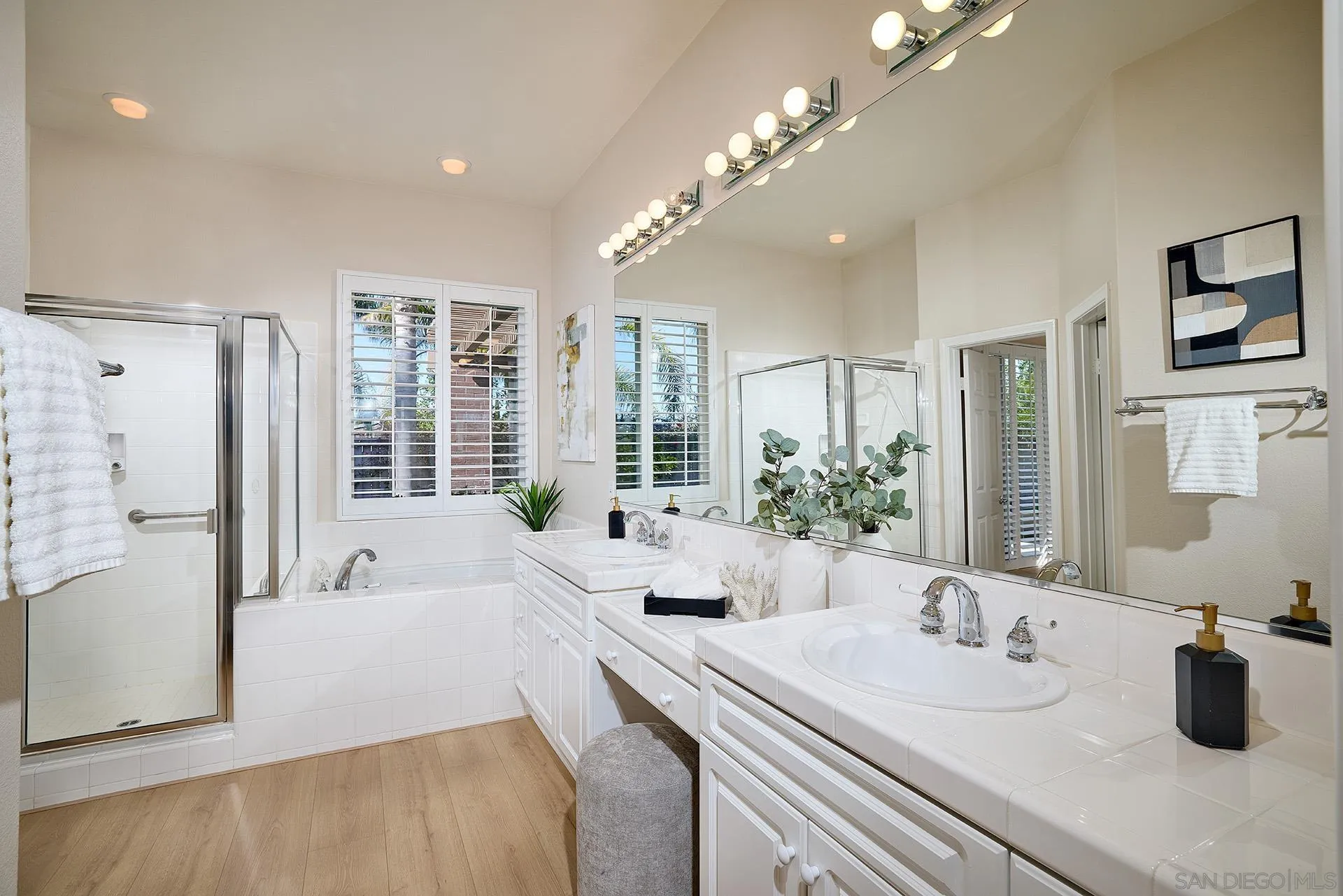6109 Paseo Tesoro Carlsbad, CA 92009 - Photo 16 of 34 a bathroom with double vanity sinks a large mirror and a shower