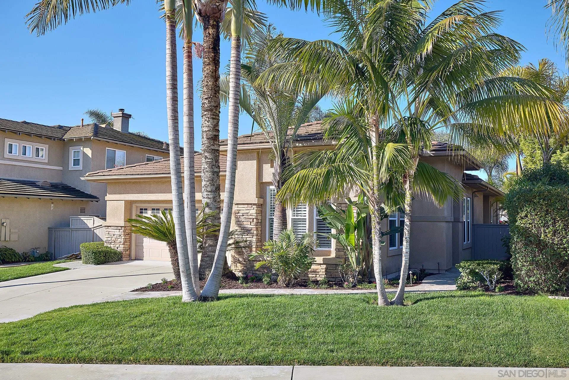 6109 Paseo Tesoro Carlsbad, CA 92009 - Photo 2 of 34 a view of a house with a yard and palm trees