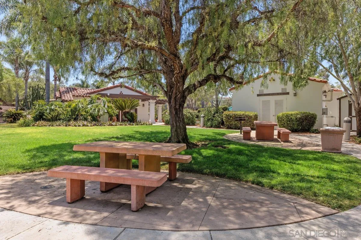 6109 Paseo Tesoro Carlsbad, CA 92009 - Photo 34 of 34 a view of a backyard with table and chairs potted plants and a large tree