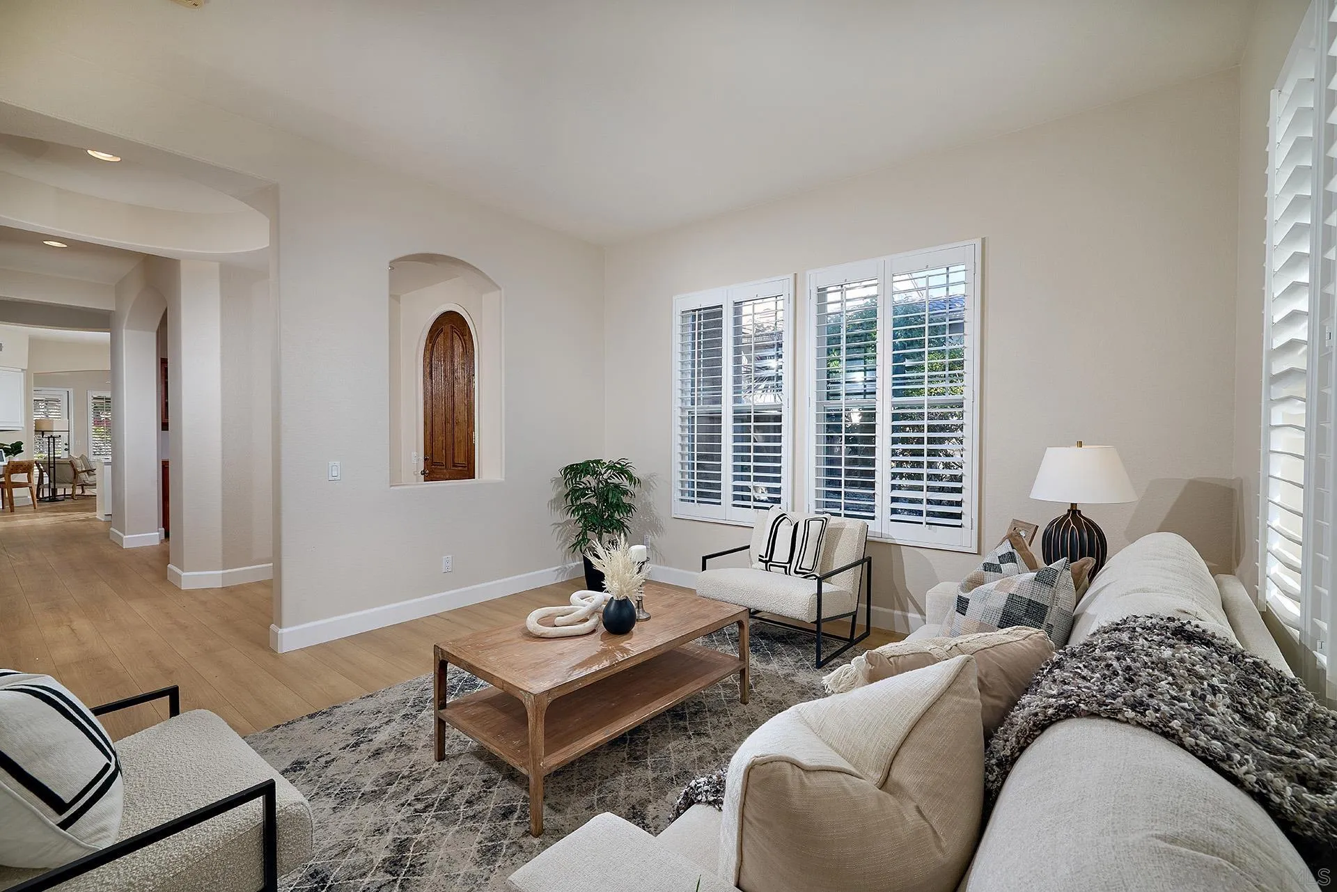 6109 Paseo Tesoro Carlsbad, CA 92009 - Photo 4 of 34 a living room with furniture and a potted plant