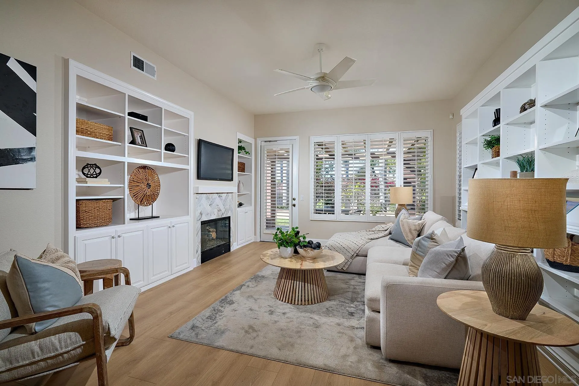 6109 Paseo Tesoro Carlsbad, CA 92009 - Photo 9 of 34 a living room with furniture a fireplace and a flat screen tv