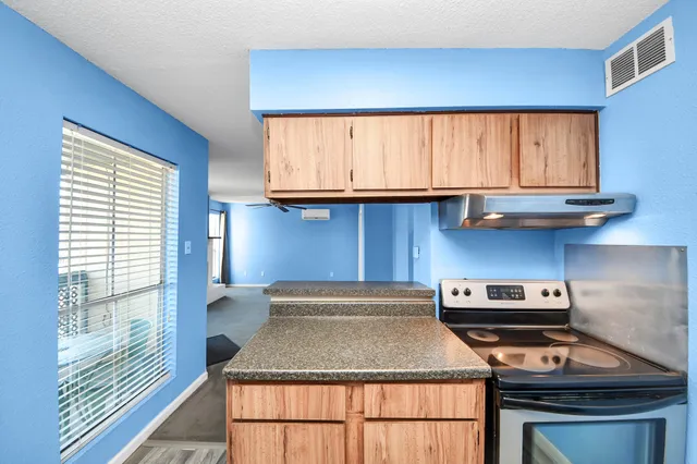 a kitchen with a stove and a microwave