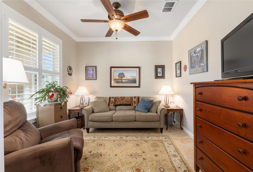 9823 Southwest 72nd Lane Ocala, FL 34481 - Photo 14 of 46 a living room with furniture and a flat screen tv