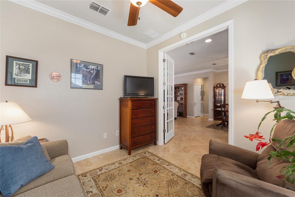 9823 Southwest 72nd Lane Ocala, FL 34481 - Photo 15 of 46 a living room with furniture and a flat screen tv