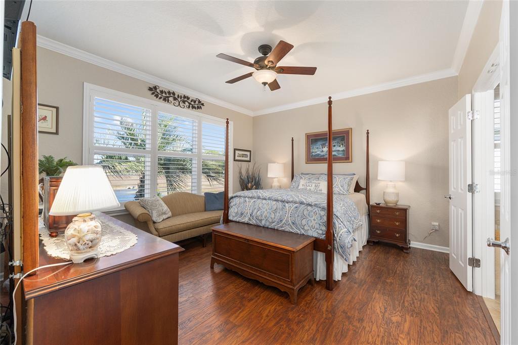 9823 Southwest 72nd Lane Ocala, FL 34481 - Photo 16 of 46 a bedroom with a bed and wooden floor