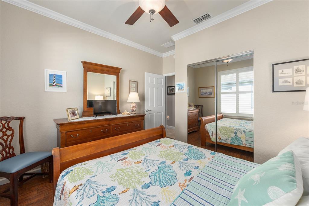 9823 Southwest 72nd Lane Ocala, FL 34481 - Photo 23 of 46 a bedroom with a bed and wooden floor