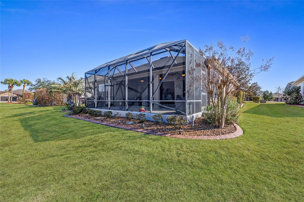 9823 Southwest 72nd Lane Ocala, FL 34481 - Photo 29 of 46 a view of a house with a yard