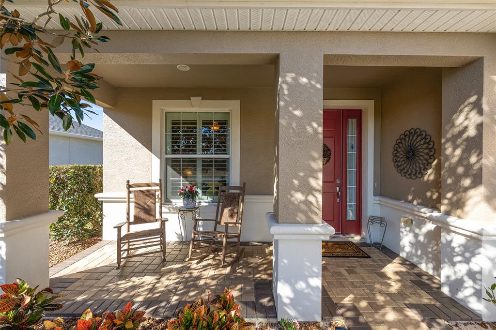 9823 Southwest 72nd Lane Ocala, FL 34481 - Photo 4 of 46 a view of a porch with chairs and entryway