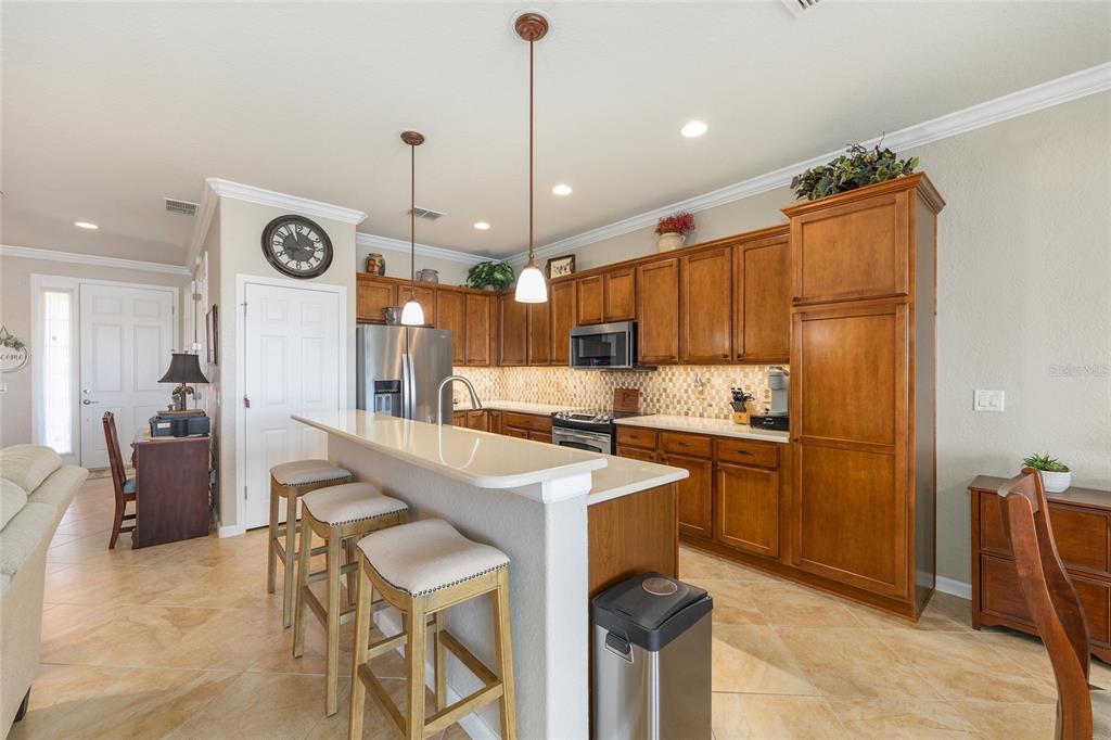 9823 Southwest 72nd Lane Ocala, FL 34481 - Photo 8 of 46 a kitchen with stainless steel appliances granite countertop a sink a stove a refrigerator and island