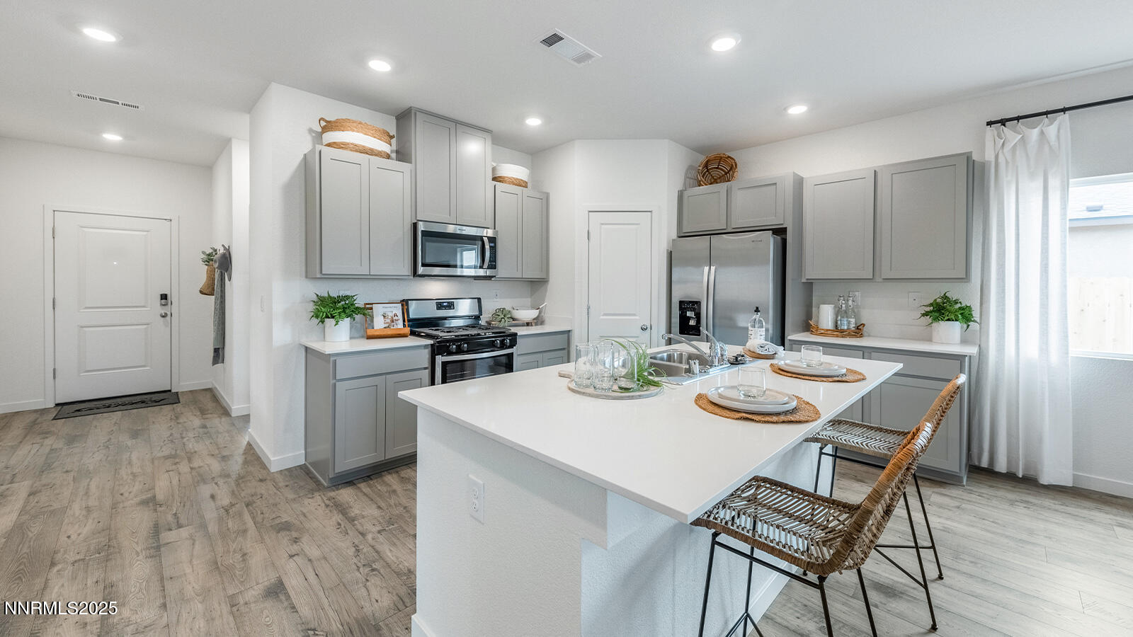 4552 Mifflin Street, Unit LOT #9 Fernley, NV 89408 - Photo 3 of 11 a kitchen with stainless steel appliances kitchen island granite countertop a sink and a refrigerator