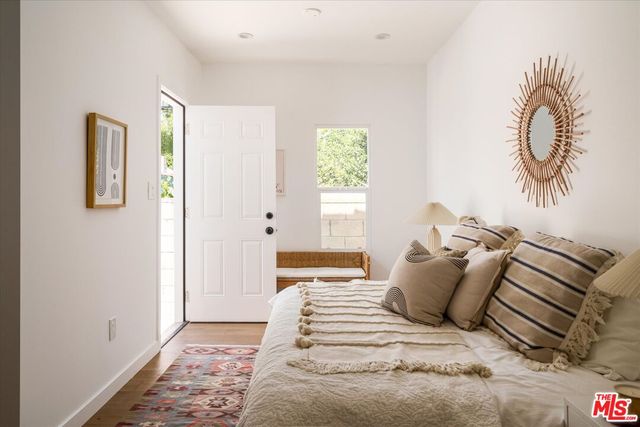 a bedroom with a bed and a painting on the wall