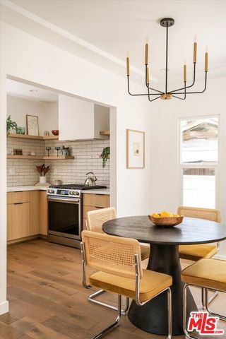 a kitchen with a sink cabinets and wooden floor