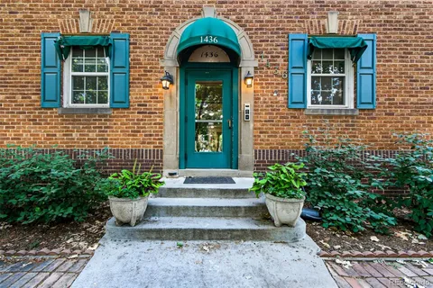 a front view of a house with plants