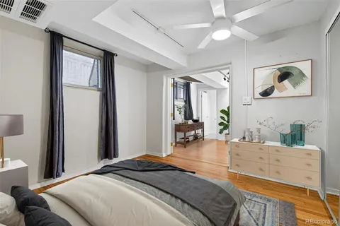 a bedroom with a bed a mirror and furniture