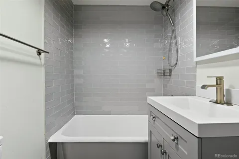 a bathroom with a sink a bathtub and shower