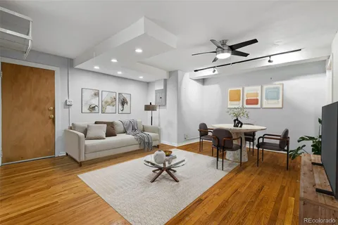 a living room with furniture and a wooden floor