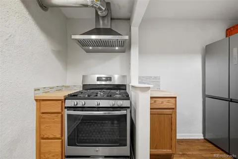 a kitchen with a stove and a refrigerator