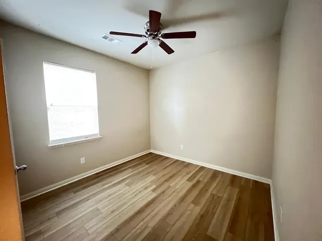a view of room with a ceiling fan