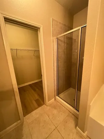 a bathroom with a tub and shower
