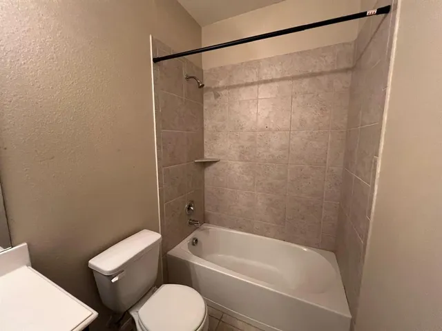 a bathroom with a toilet and a bath tub
