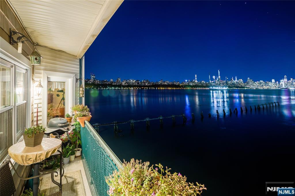 116 The Promenade, Unit 116 Edgewater, NJ 07020 - Photo 25 of 26 a view of balcony with furniture and a yard